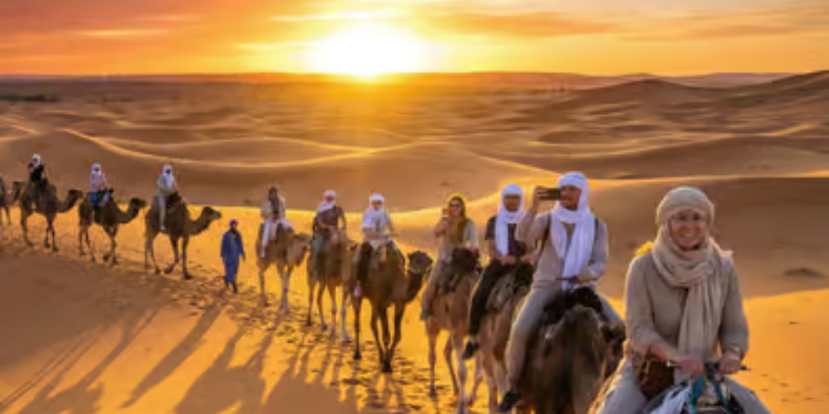 Sahara desert camel caravan sunset in Morocco